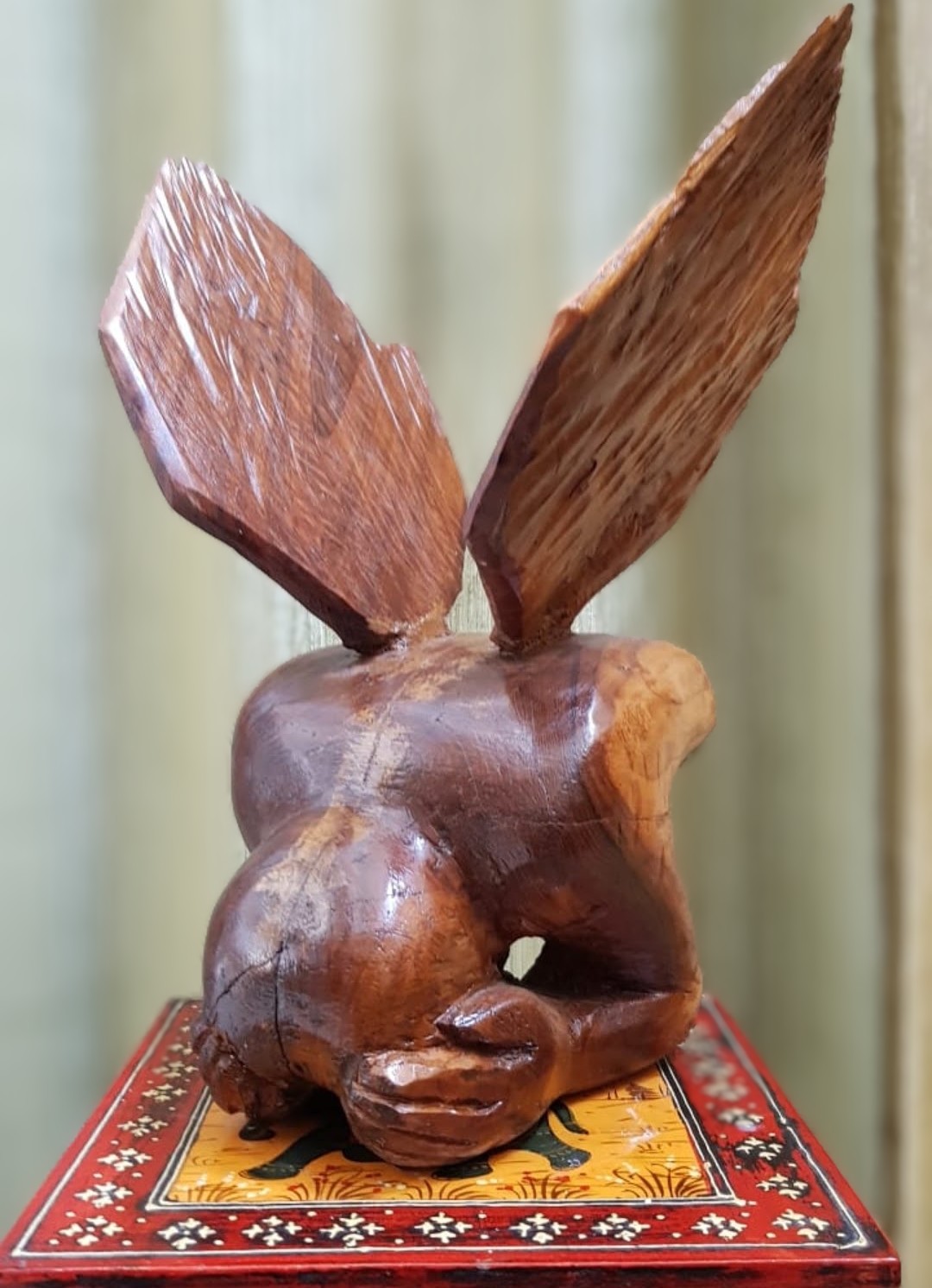 Carved wooden sculpture of a rabbit with tall ears