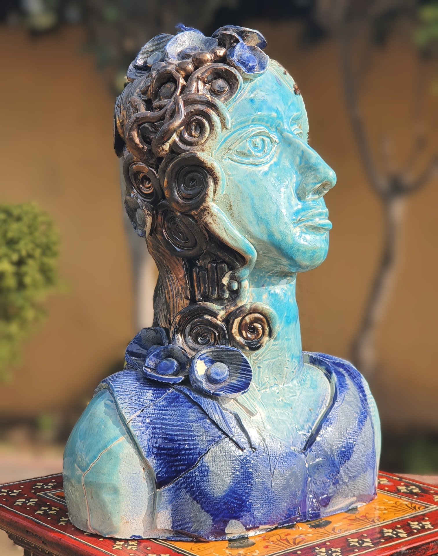Turquoise and blue glazed ceramic bust with spiral detailing